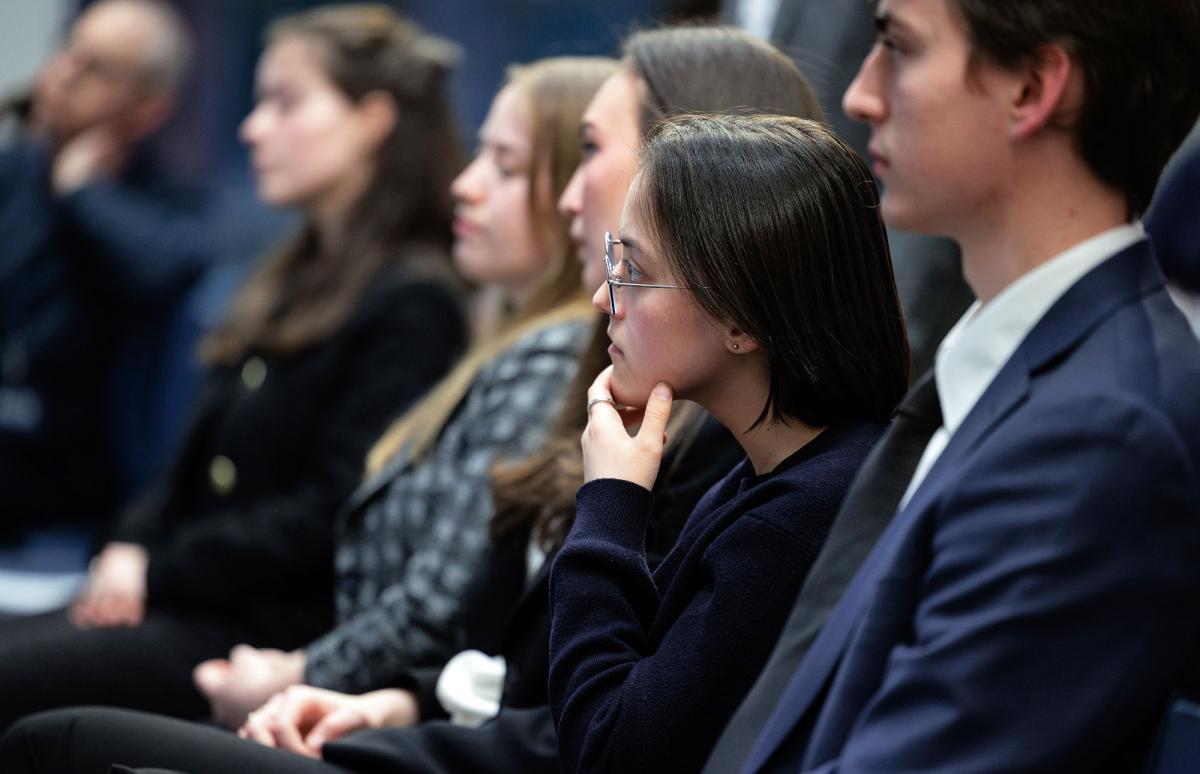 Pace University students listening and watching President of the Federal Reserve Bank of New York, John Williams, speaking